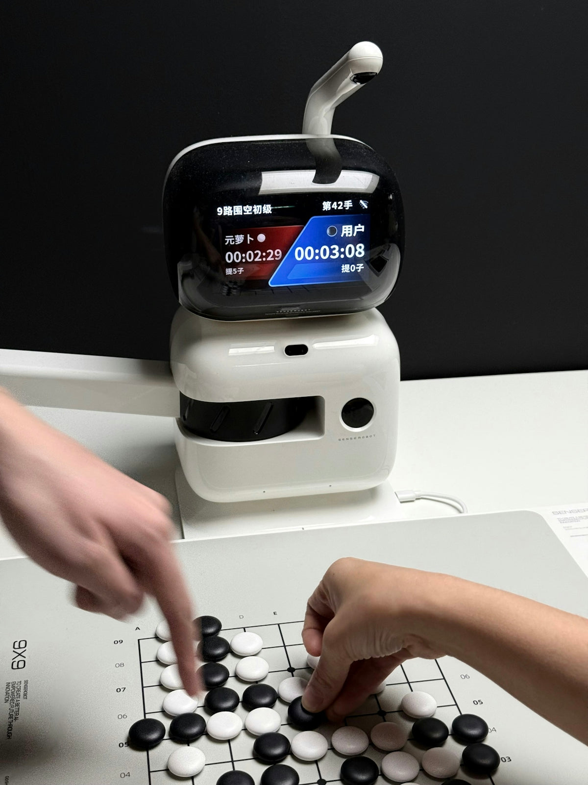 Robot watching people play go board game