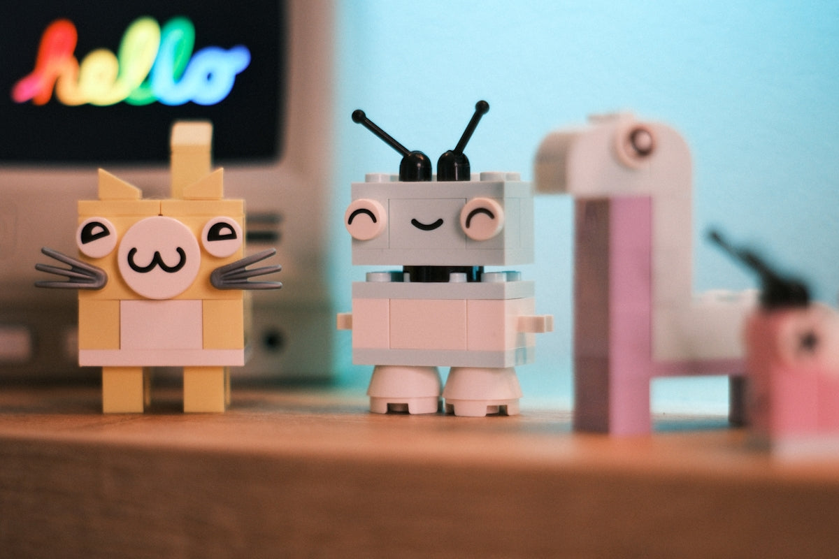 Lego cat and robot figures with a hello computer display.